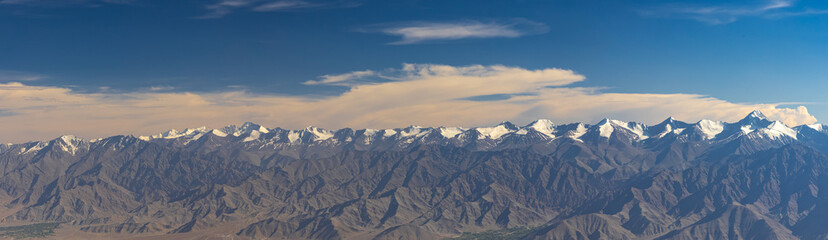 A panoramic landscape view of the Zanskar mountain range as viewed from Khardungla top.