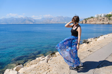 Fototapeta premium Asian female tourist and blue mediterranean sea, in Antalya, Turkey