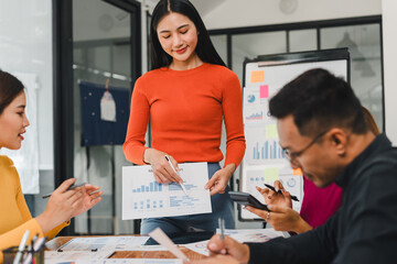 woman presenting data to team in modern office