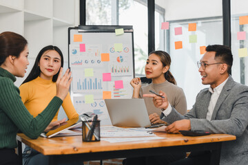 Team discussing business strategy with charts and sticky notes