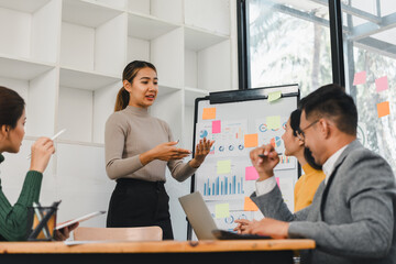 woman presenting ideas to team in modern office