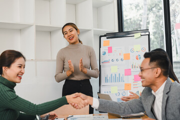 Business team celebrating success in modern office meeting