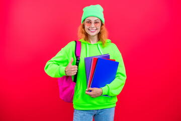 Knowledge and education. School education. Modern education. Girl student hold workbook. Back to school. Knowledge day. Education in college. Homework of girl isolated on pink. Thumb up