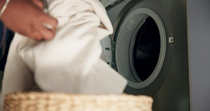 Cleaning, hands and clothes in washing machine with laundry for housekeeping, fresh linen and morning routine. Hygiene, person and loading fabric in appliance for domestic chores and home maintenance