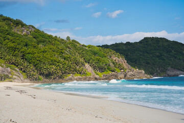 Beautiful isolated white sandy of police bay, turquoise water, lush vegetation, Mahe, Seychelles