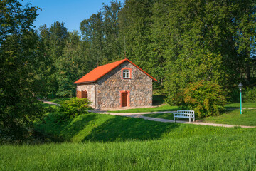 A traditional stone barn for storing flax on the shore of the pond 