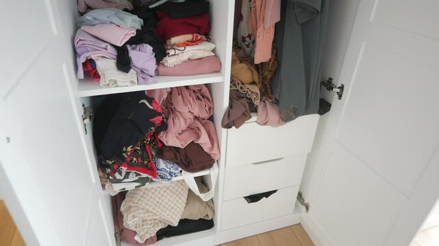 A Disorganized Closet Filled with Mixed Clothing Items and Various Accessories