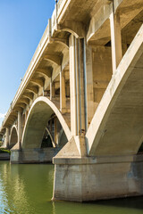 A bridge with a large arch over a river