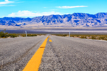 A long road with a yellow line down the middle