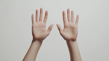 Isolated human hands raised against a clean white background symbolizing openness and communication in a minimalist setting