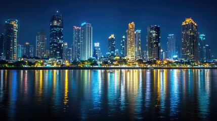 Night view of a vibrant business district with skyline reflections in the water showcasing modern architecture and city lights