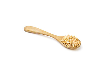 Oat groats on wooden spoon isolated on white background. Oats contain nutrients that help prevent many diseases, boost immunity, regulate blood sugar levels, and lower cholesterol.