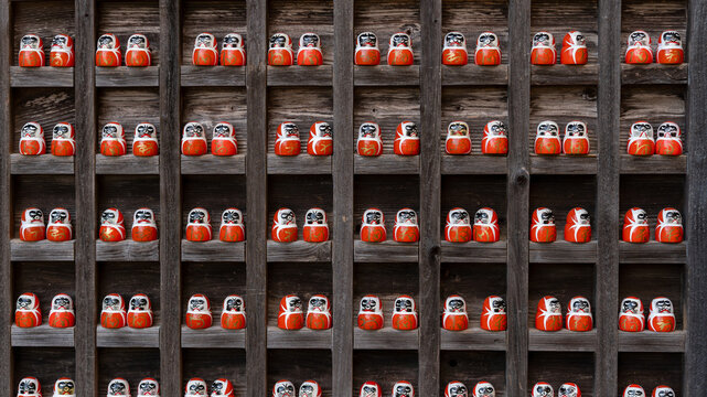 A Daruma doll is a hollow, round, Japanese traditional doll modelled after Bodhidharma, the founder of the Zen tradition of Buddhism. These are smaller Darumas. 