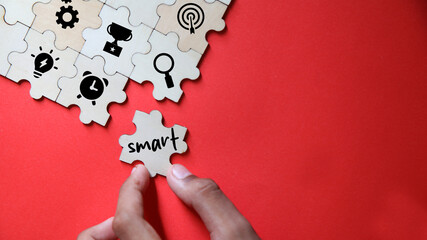 Business and SMART symbol. Wooden blocks with words 'SMART, specific measurable achievable realistic timely'. Yellow background, copy space. Business and SMART concept.