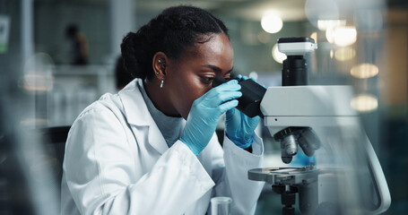 Black woman, scientist and microscope for genes research and medical study with pharma...