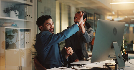 Fototapeta premium Man, woman and high five by computer in office for success, deal or goals in collaboration at night. Business people, partnership and celebration for achievement, profit or target at creative agency