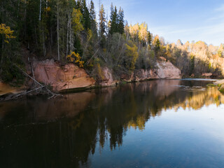 Latvian nature, sandstone cliff Kuku, Gauja river on an autumn day, drone aerial view.