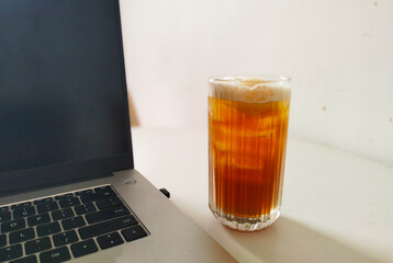 white desk and glass of iced coffee