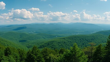 Obraz premium Stunning Aerial Panorama, Lush Green Forest and Rolling Mountains of New Hampshire under a Blue Sky with Puffy Clouds
