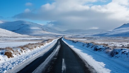 Stunning Snowy Irish Road, Serene Winter Landscape Photography. Snow-Covered Hills, Blue Sky, Asphalted Road. Breathtaking Winter Scenery in Ireland.