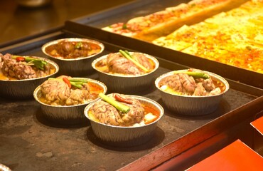 close up of boiled pork brain with celeryand heab soup street food in market on China