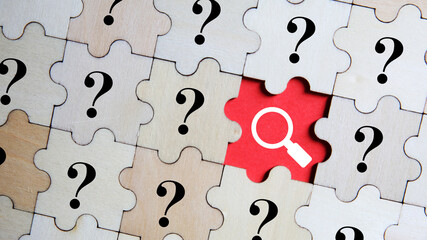 Magnifying glass and question mark signs on blue background. Searching for information, data,...