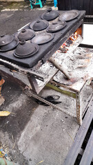 Traditional stove with firewood for making coconut milk pancake