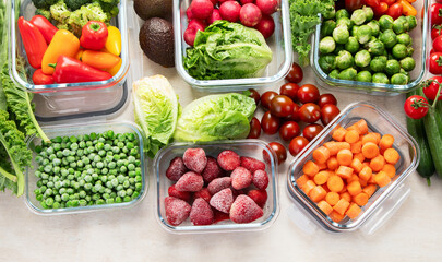 Boxes with fresh raw vegetables on table.