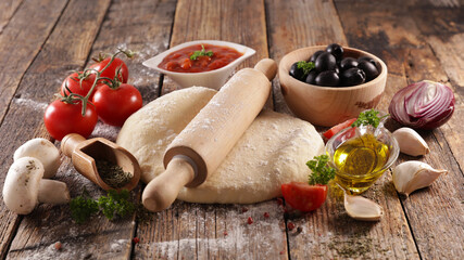 raw pizza dough with fresh ingredients