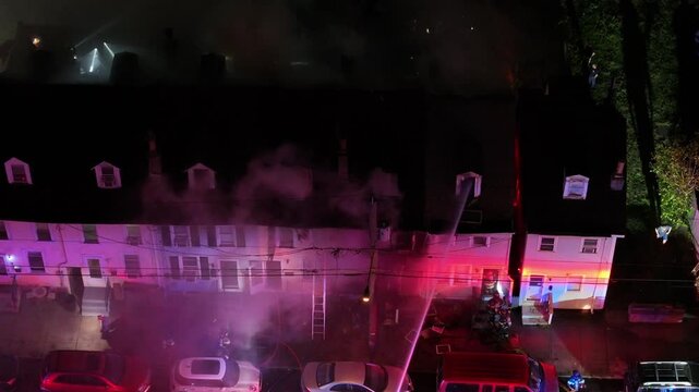 Firefighters Entering Burning Row Homes As Flames Shoot Through Roof