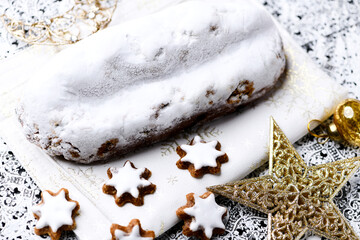 Christmas strudel with marzipan and cinnamon stars on bright background. Close up. 