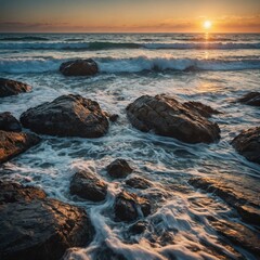 Obraz premium A beach with waves breaking on a rocky coastline at sunset.