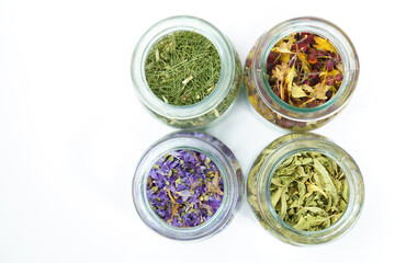 top view of glass jars with medicinal plants on white background and copy space ,naturopathic concept