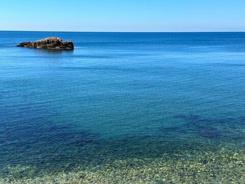 Calm sea blue water and sky at morning on Mediterranean coast.