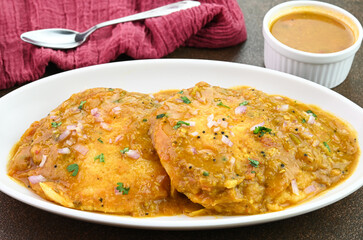 Serving Idli Sambar south indian breakfast in a plate.