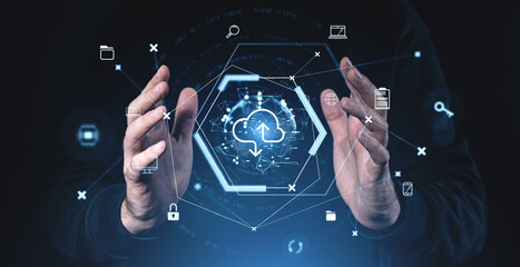 Cloud storage concept with hands interacting with a digital interface of icons and network connections in blue tones on a dark background.