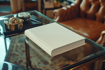 A pristine white photo album rests on a glass-top table, near antique-looking desk accessories.  The elegant setting hints at cherished memories.