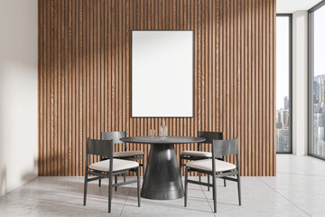 Modern dining area with round table, chairs, and a blank vertical frame on wooden slatted wall in bright room with cityscape view. 3D Rendering