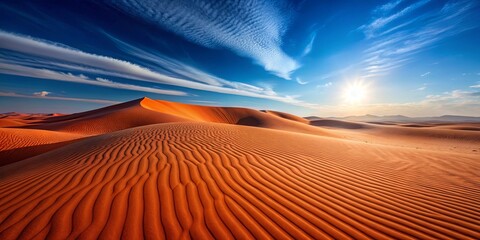 Naklejka premium Serene desert landscape at sunset, with vibrant orange sand dunes and a breathtaking blue sky filled with wispy clouds