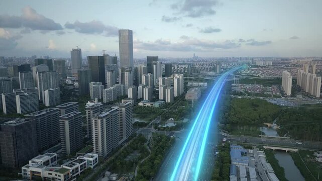 Aerial sunset cityscape of modern smart city with animation of lights trails on main highway fast internet optical fibre digital revolution technology concept