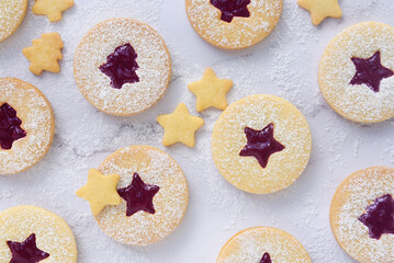 Christmas linzer cookies, shortbread cookies with homemade mix berry jam..