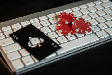 Keyboard, ace of spades and poker chips
