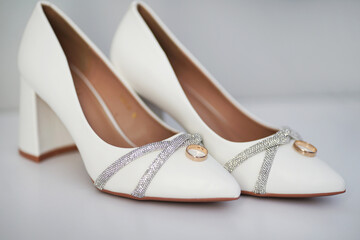 The bride's sandals and gold wedding rings on them. Preparation for the wedding.