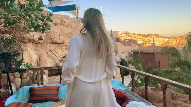 A beautiful girl in traditional clothes rests in a cafe in Egypt