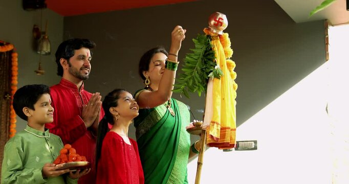 Happy Indian Family in Traditional Wear Performing Gudi Padwa Puja Outdoors, Celebrating Hindu New Year with Kids