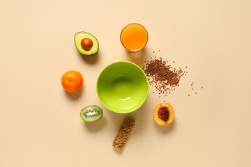 Empty bowl with juice and ingredients on beige background
