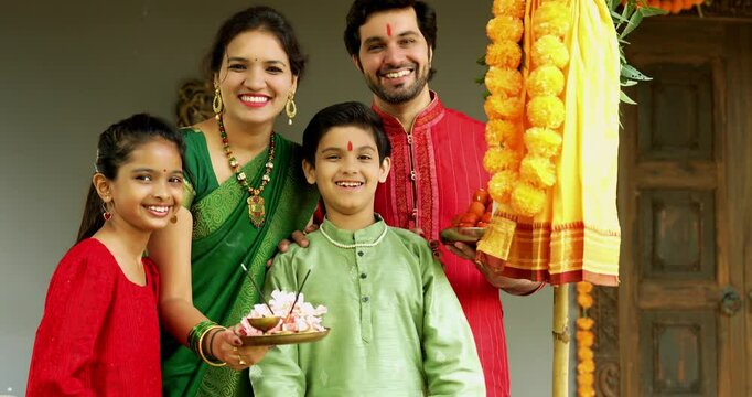 Portrait of Happy Indian Family in Traditional Attire Smiling After Gudi Padwa Puja Outdoors, Celebrating Hindu New Year with Kids