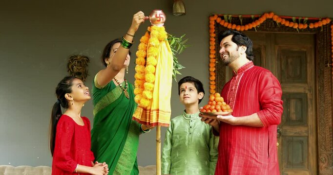 Happy Indian Family in Traditional Wear Performing Gudi Padwa Puja Outdoors, Celebrating Hindu New Year with Kids