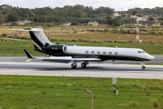 Luqa, Malta - December 3, 2024:  Avcon Jet Gulfstream Aerospace G-V Gulfstream V (REG: OE-IIS) landing runway 31 on a cloudy morning.