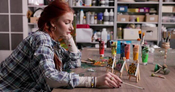 A Creative Artist in Their Studio Deep in Thought and Contemplating Their Artwork